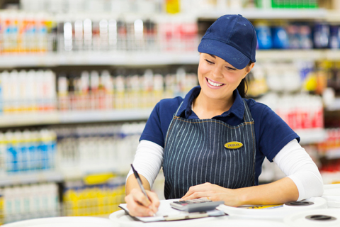 beautiful store clerk writing stock in supermarket
